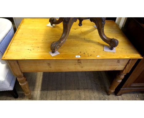 An early to mid 20th Century pine kitchen table raised on column supports.