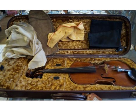 A vintage violin having mother of pearl decoration, having two piece back fitted in modern case with bow.