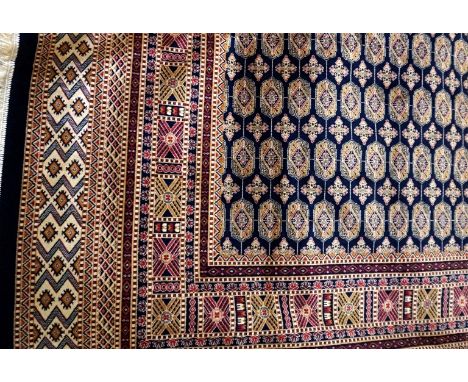 A Bokhara carpet, on a predominantly blue ground with stylised motifs, 2.80x2.00