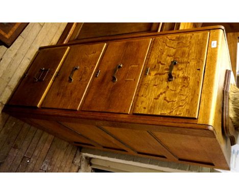 A stylish light oak four drawer filing cabinet