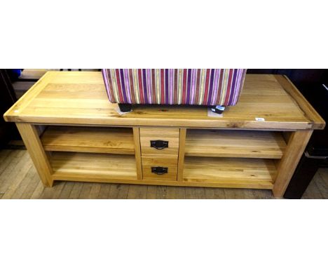 A reproduction light oak television stand, having two base drawers and two fixed shelves.