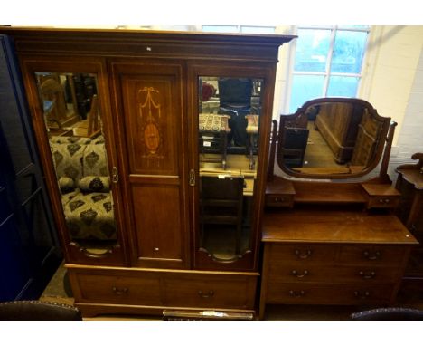 An Edwardian inlaid mahogany bedroom pair comprising mirror door wardrobe and mirrored back dressing table.