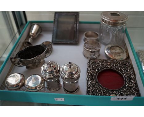 A collection of assorted hallmarked silver to include a pair of pepperettes, lidded dressing table pot, pocket watch holder, 