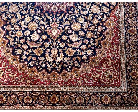 A Keshan carpet on a blue ground with floral motifs, 2.80 x 2.00.