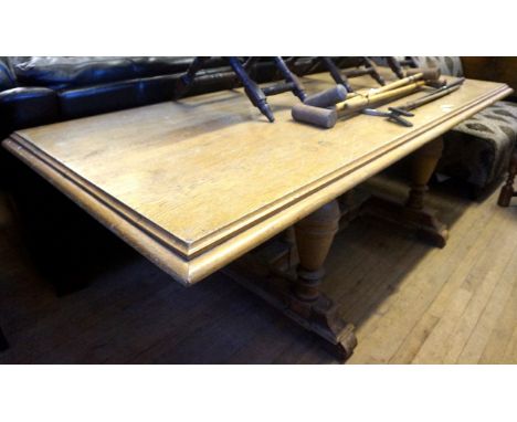 An mid 20th Century light oak refectory table, raised on baluster form supports.