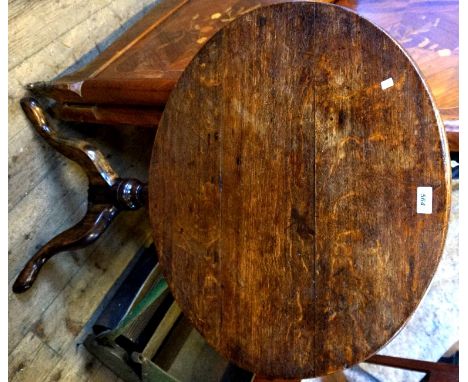 An 18th Century light oak tripod table raised on outswept supports.