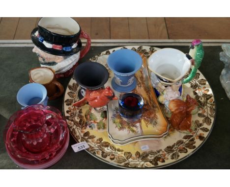 A large mixed group of ceramics to include a Royal Doulton Beefeaters character jug a Beswick Beatrix Potter 'Squirrel Nutkin