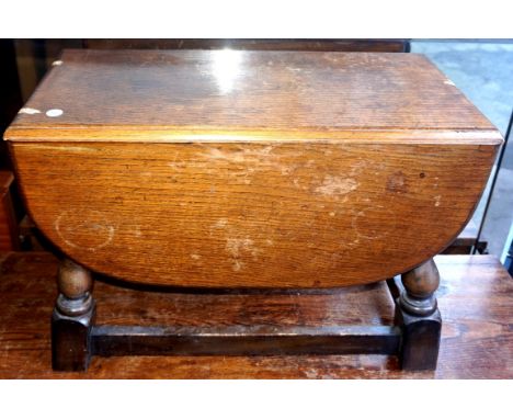 A reproduction oak drop leaf coffee table together with a circular topped example.