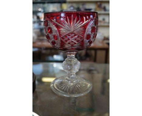 A ruby red Bohemian cut glass goblet.