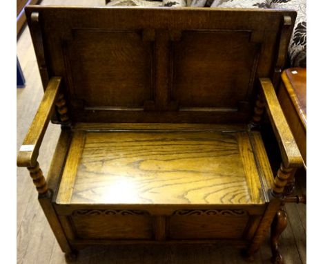 A mid 20th Century solid oak  monks bench, the seat enclosing a storage compartment.