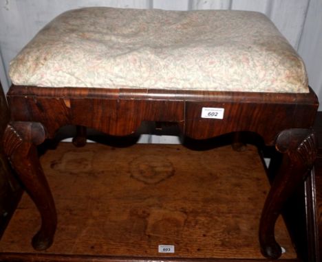 An early 19th century rosewood veneered dressing table stool, having carved cabriole supports.