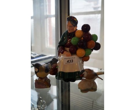 A Royal Doulton figurine HN1315 The Old Balloon Seller, together with two Royal Worcester birds.