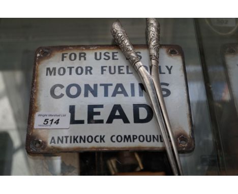A Chinese white metal glove stretcher relief decorated with dragons together with a vintage enamel sign For Use as Motor fuel