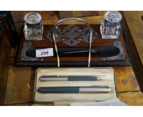 A mid 20th Century mahogany desk stand with two inkwells, together with two Parker pen, together with a Pitra dura  tie pin