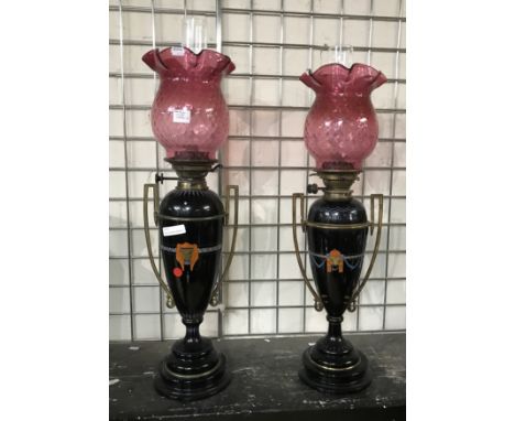 PAIR OF VICTORIAN CERAMIC OIL LAMPS WITH ORIGINAL HINKS NO.2 BURNERS &amp; MATCHING PAIR OF CRANBERRY GLASS SHADES 72CMS (H)