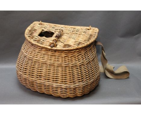 Vintage wicker fishing creel, with wooden peg locking device, canvas and leather strap. 