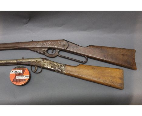 Two BB guns, (Ucton Model 40 patented June 30th 1914 and a Milbro Scout), and a vintage Milbro Caledonian 22 pellet tin marke