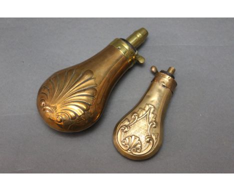 Two powder flasks, the first marked Dixon &amp; Son with shell decoration, overall length 15 cm, and a pistol flask measuring