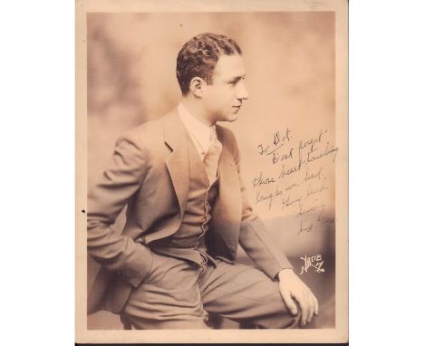 Portrait of an elegantly dressed gentleman in a grey and white suit.Hand signed in legible writing: To Pat, Donâ€™t forget th