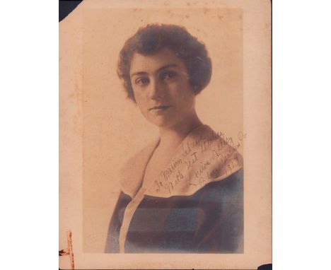 Albumen print of dark hair woman, dressed elegantly for photograph.Hand signed legible writing: To Marim Leland. With best wi