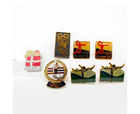 Includes: two Kodak 1992 advertising pins; Misha, 1980 Moscow; Lillehammer 1994; Squaw Valley, 1960 depicting H. Brusveen; an