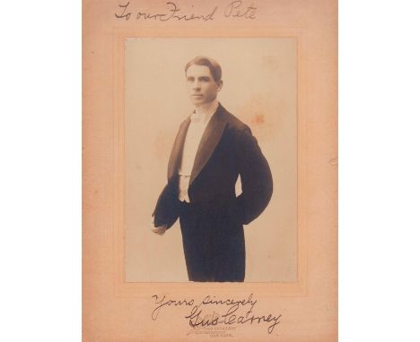 Portrait of an elegantly dressed man, posing for photo.Hand signed legible writing To our friend Pete. Yours sincerely Gus. B
