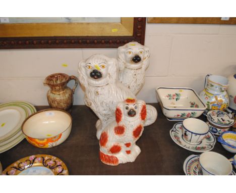A pair of Victorian Staffordshire spaniels and a smaller red patch example 