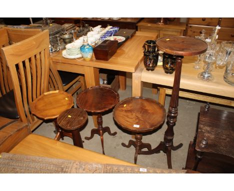 Three wine tables raised on tripod base, a pine plant stand and mahogany plant stand raised on tripod base with fluted column