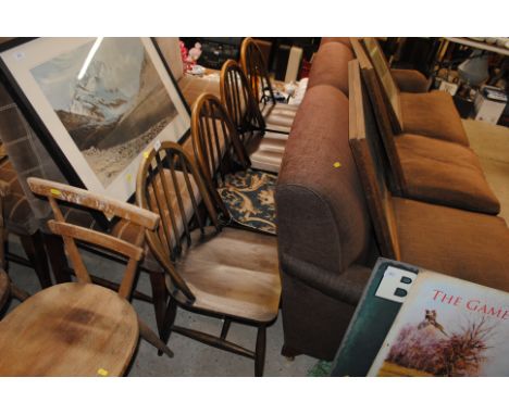 A set of four Ercol elm seated stick back dining chairs 