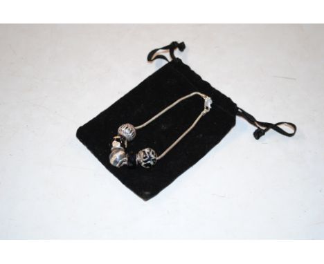 An Amore & Baci Sterling silver charm bracelet with Murano glass charms 