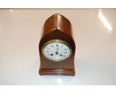 An Edwardian mahogany chequer strung lancet shaped two hole mantel clock 