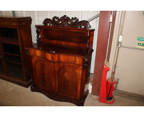 A Victorian mahogany chiffonier of serpentine shape decorated swans