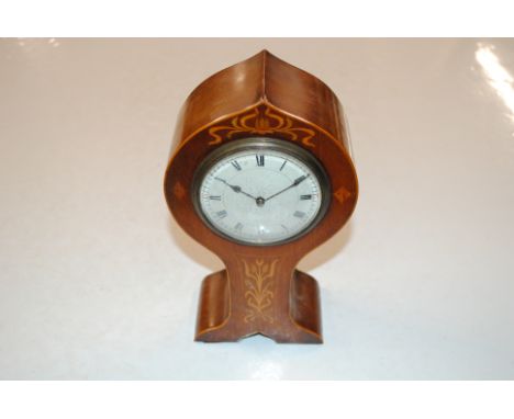 An Edwardian mahogany inlaid cased mantel clock, the back of the movement stamped with a lion 