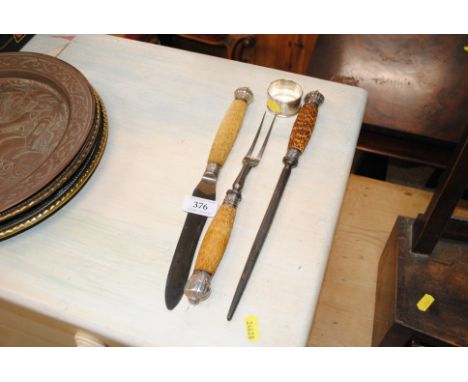A horn handled and silver collared meat carving set and a silver napkin ring, inscribed to the inside 