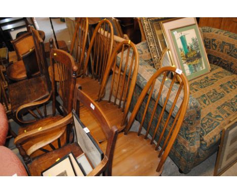 A set of four Ercol stick back dining chairs 