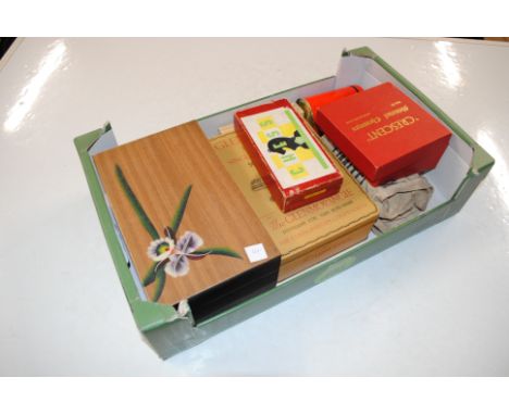 A box containing chess pieces, dominoes and a jewellery box