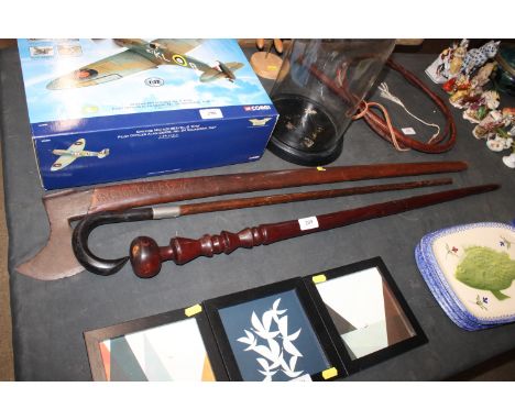 A long handled axe; a carved mahogany walking stick; and a horn handled walking stick