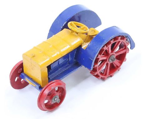 Dinky Toys No. 22E Farm Tractor comprising of dark blue and yellow with red spoked wheels - the model has minimal wear