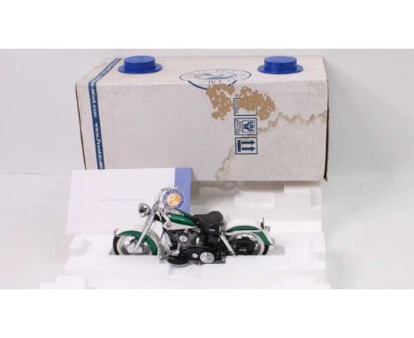 A Franklin Mint Precision Models 1/10 scale model of a 1958 Harley Davidson Duo-Glide with paperwork and in its original pack