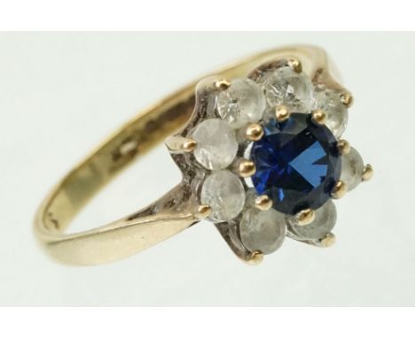 9ct gold sapphire and white stone halo ring. The ring being set with around brilliant cut sapphire surrounded by white stones