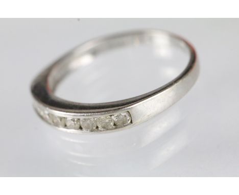 9ct white gold and diamond half eternity ring. The ring being channel set with nine round brilliant cut diamonds. Hallmarked 