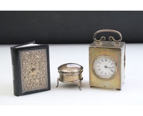 Early 20th Century silver cased mantle clock, the case of plain rectangular form with swing handle to top, wit round face wit