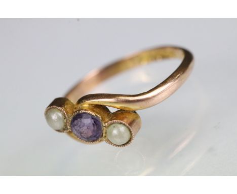 Early 20th Century 9ct gold amethyst and faux pearl three stone cross over ring. Hallmarked Birmingham 1919. Size M.5. 