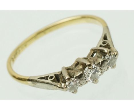 18ct gold and diamond three stone ring. The ring being set with three round brilliant cut diamonds in prong settings. Shank m