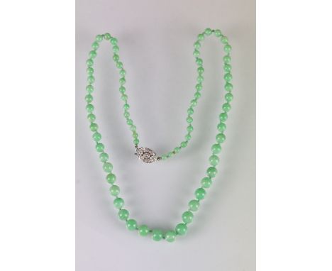 Green Jadeite jade necklace constructed from round beads on a knotted string with a 14ct white gold diamond set clasp. Clasp 
