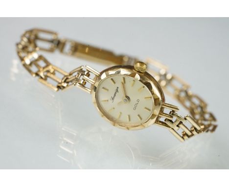 Ladies Sovereign Gold 9ct gold wrist watch. The watch having an oval face with sunburst dial, baton markers to the chapter ri