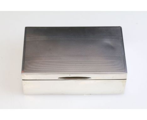 Mid Century silver hallmarked cigarette box having engine turned detailing to lid. Hallmarked Birmingham 1947. Measures 14cm 