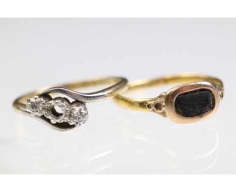 Two rings to include an 18ct and platinum three stone ring (one stone missing, marked 18ct &amp; plat), and a yellow metal ri