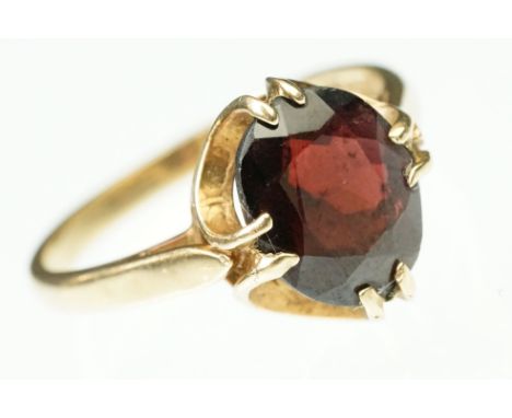 9ct gold and garnet ring. The ring being set with an oval faceted garnet in a buttercup setting. Hallmarked Birmingham 1971. 