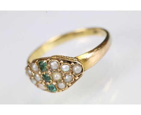 18ct gold emerald and seed pearl ring. The ring being set with three step cut emeralds to the centre surrounded by seed pearl